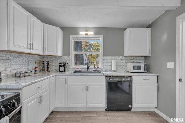 kitchen featuring white cabinetry, light hardwood / wood-style flooring, black appliances, and sink