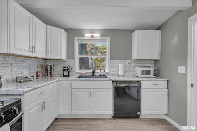 906 28 1/2 St, Bettendorf, IA 52722 - kitchen featuring black dishwasher, white microwave, stove, white cabinets, and light wood finished floors