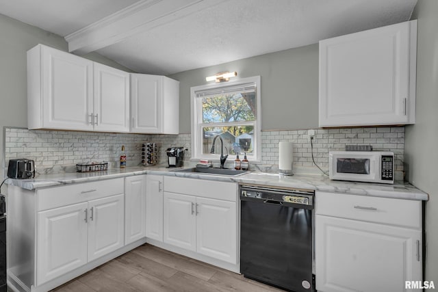 906 28 1/2 St, Bettendorf, IA 52722 - kitchen featuring black dishwasher, white microwave, light wood finished floors, and tasteful backsplash