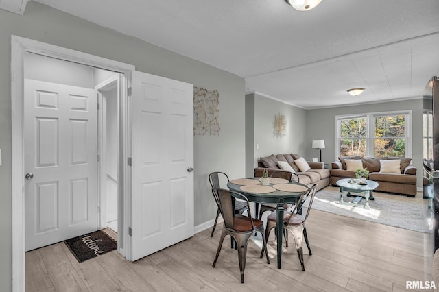 906 28 1/2 St, Bettendorf, IA 52722 - dining area with light wood-type flooring and ornamental molding