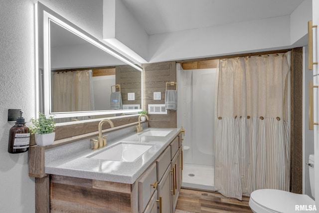 bathroom with vanity, hardwood / wood-style floors, a shower with curtain, and toilet