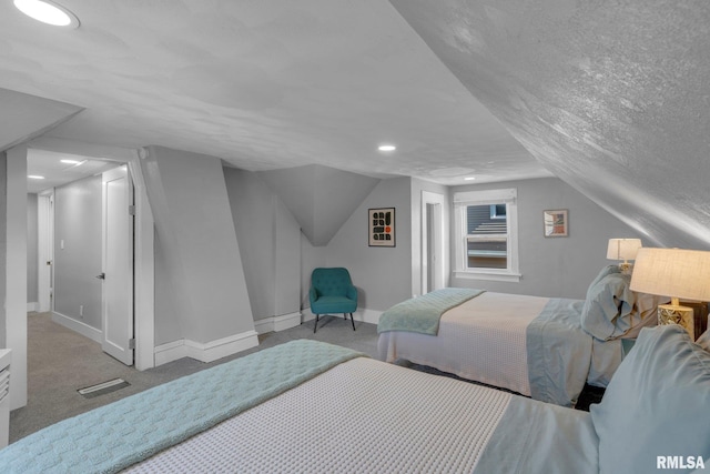 bedroom featuring a textured ceiling, carpet, and vaulted ceiling