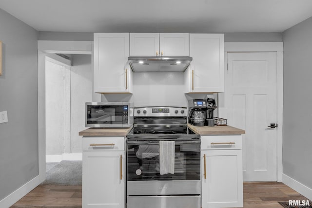 kitchen with appliances with stainless steel finishes, white cabinets, exhaust hood, and light wood-type flooring