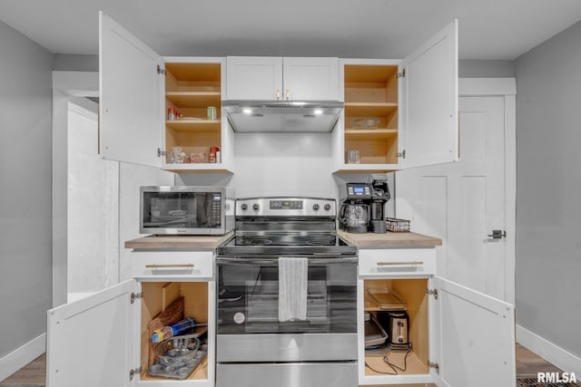 kitchen with white cabinetry, stainless steel appliances, and light hardwood / wood-style flooring