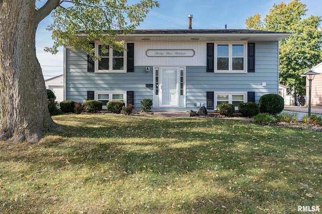 raised ranch with a front yard