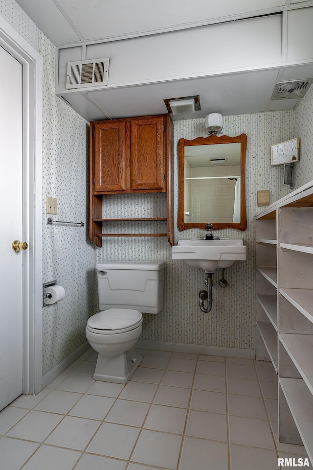 bathroom featuring tile patterned floors, toilet, and sink