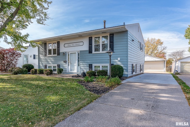 raised ranch with a garage, an outdoor structure, and a front yard