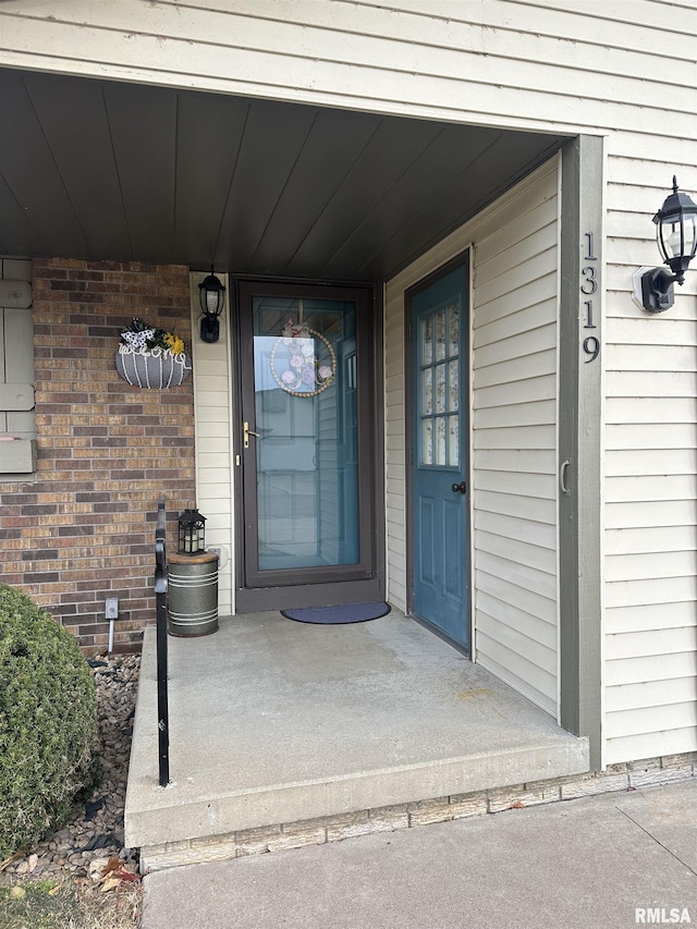 view of exterior entry featuring a porch