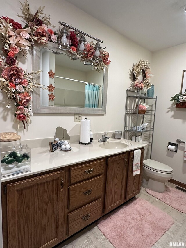 bathroom featuring visible vents, vanity, a shower with shower curtain, and toilet