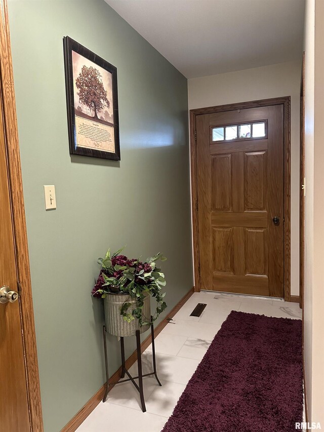 entryway featuring baseboards
