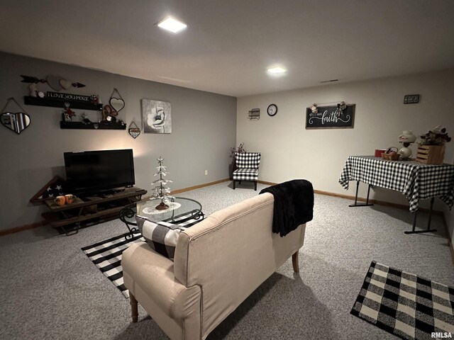 living area featuring baseboards and carpet floors