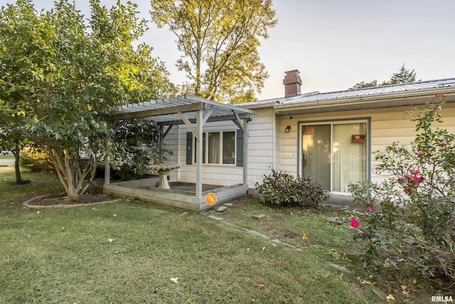 back of property with a lawn and a pergola