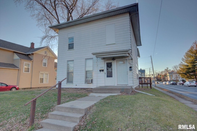 view of front of house featuring cooling unit and a front lawn