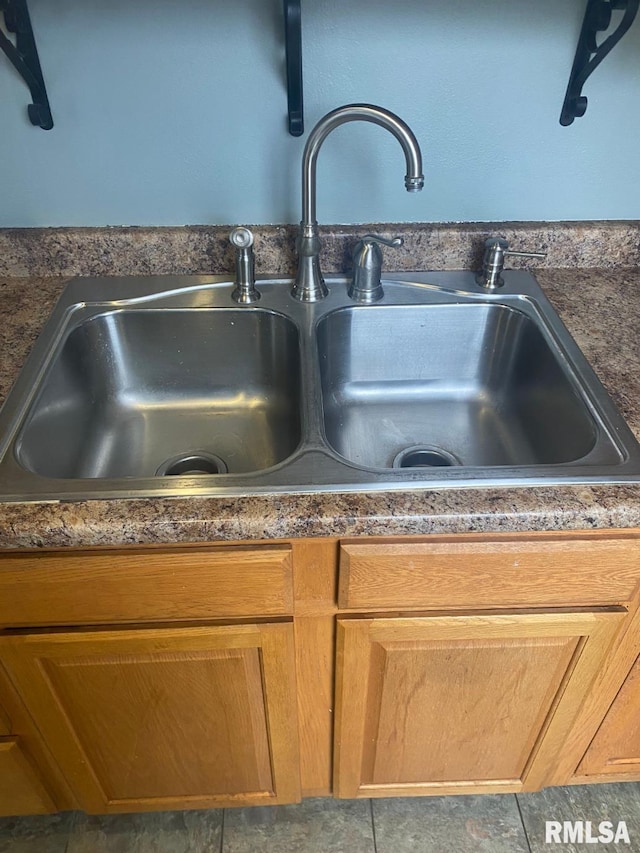 interior details featuring sink and tile patterned flooring