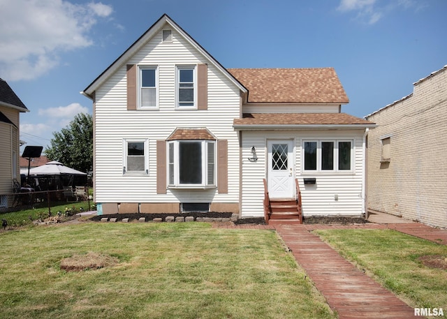 rear view of property with a yard