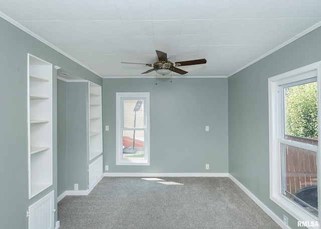 1325 13th Ave, East Moline, IL 61264 - carpeted spare room with a ceiling fan, ornamental molding, and built in features