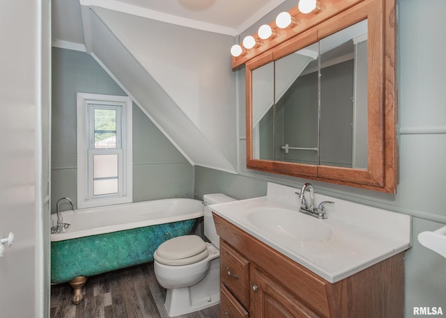 bathroom featuring toilet, a washtub, hardwood / wood-style floors, crown molding, and vanity