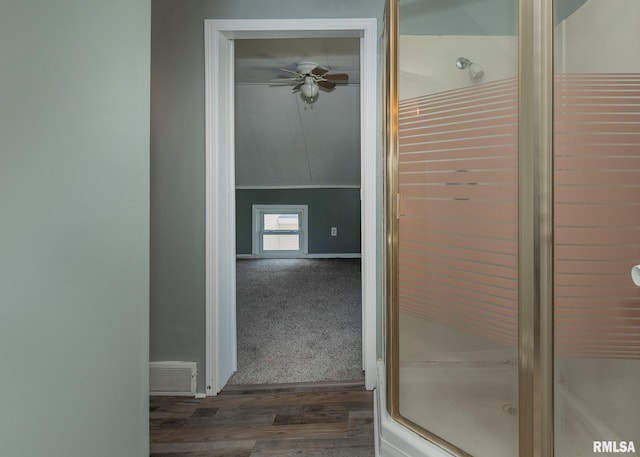 bathroom with lofted ceiling, hardwood / wood-style flooring, an enclosed shower, and ceiling fan