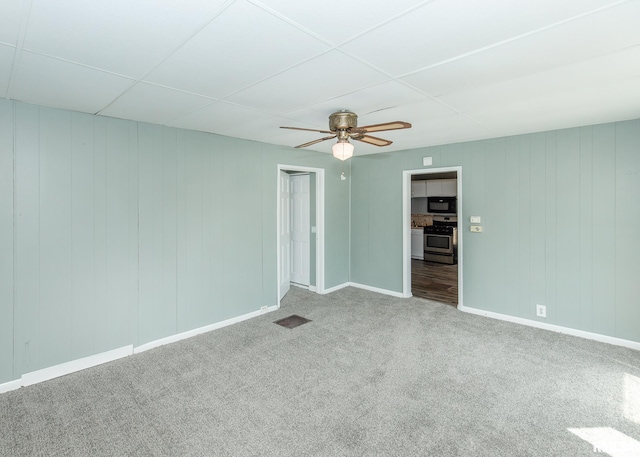 1325 13th Ave, East Moline, IL 61264 - carpeted empty room with a ceiling fan and baseboards