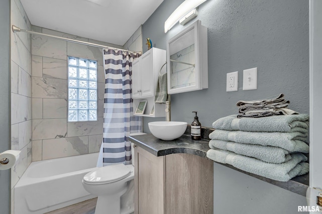 full bathroom with vanity, toilet, wood-type flooring, and shower / tub combo