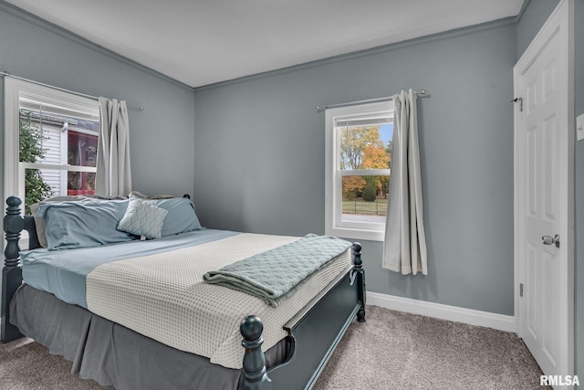 carpeted bedroom featuring crown molding