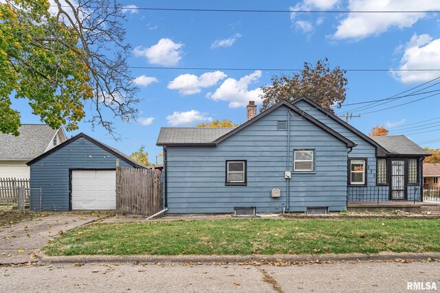235 W 32nd St, Davenport, IA 52803 - view of property exterior featuring an outbuilding, a chimney, concrete driveway, and a detached garage