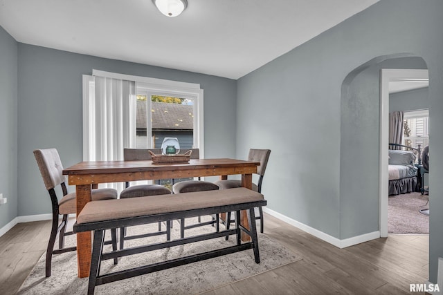 dining space with wood-type flooring