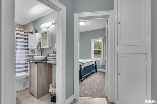 bathroom featuring vanity, hardwood / wood-style floors, and toilet