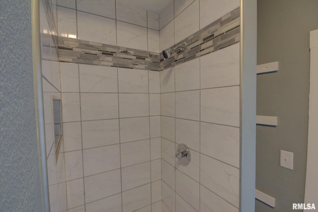 bathroom with tiled shower