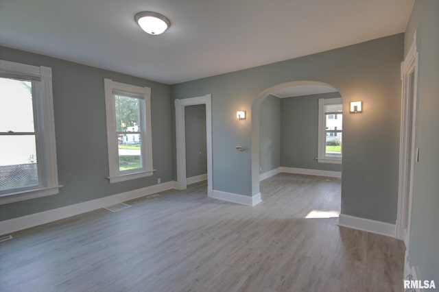 2312 W 1st St, Davenport, IA 52802 - spare room with arched walkways and wood finished floors