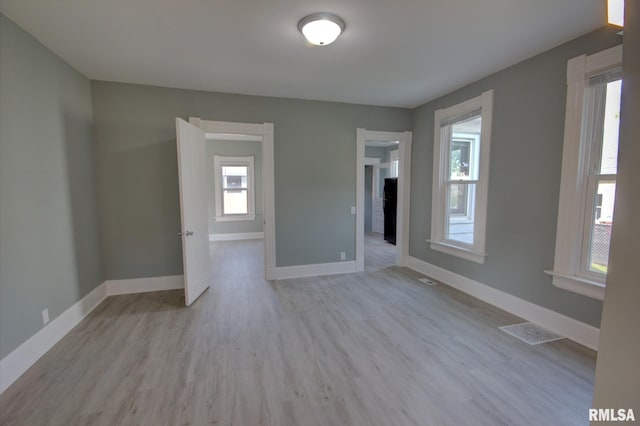 spare room featuring light hardwood / wood-style flooring