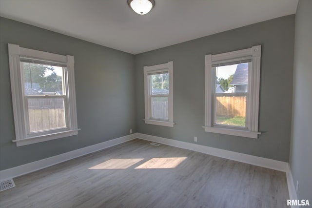 unfurnished room with light wood-type flooring