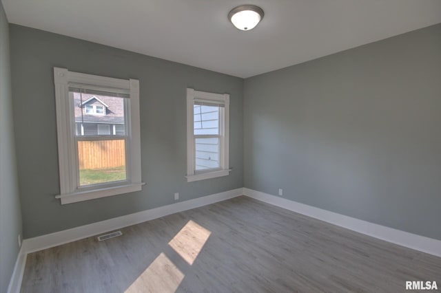 2312 W 1st St, Davenport, IA 52802 - spare room featuring wood finished floors and baseboards