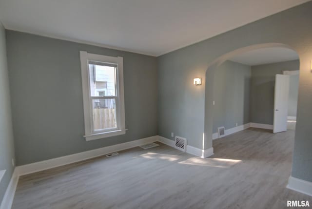 unfurnished room with light wood-type flooring