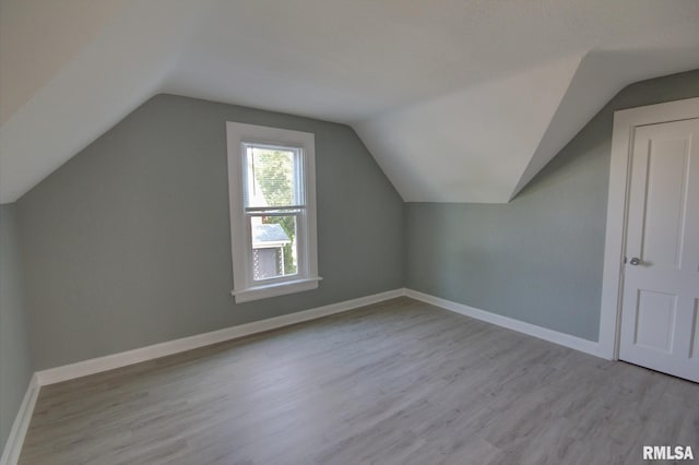 bonus room featuring light hardwood / wood-style flooring and vaulted ceiling