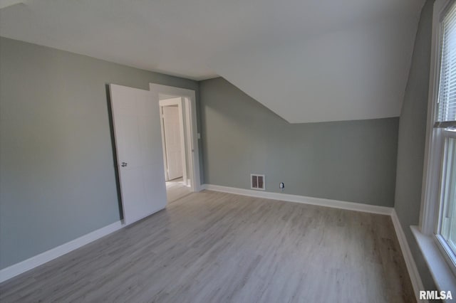2312 W 1st St, Davenport, IA 52802 - bonus room with wood finished floors, healthy amount of natural light, and vaulted ceiling