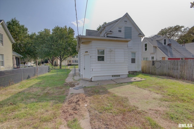 2312 W 1st St, Davenport, IA 52802 - rear view of house with a fenced backyard