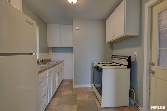 kitchen with sink, white cabinetry, and white appliances