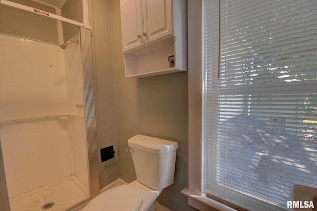 bathroom with toilet and walk in shower