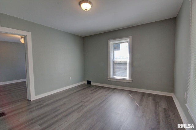 unfurnished room with hardwood / wood-style floors