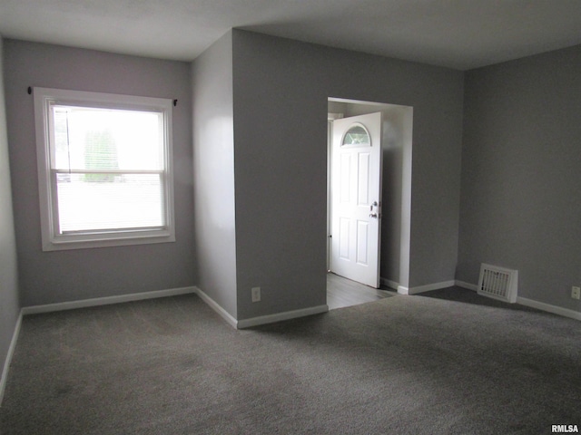 empty room featuring dark carpet