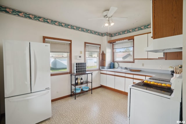 kitchen with white cabinets, white appliances, ceiling fan, and sink