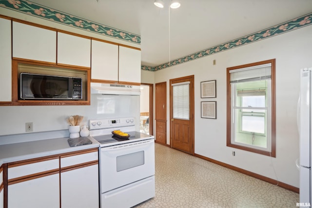 kitchen with white cabinetry and white appliances