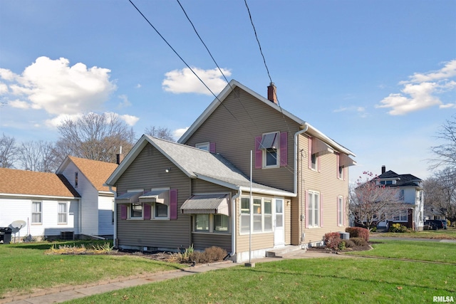 rear view of house featuring a yard and cooling unit