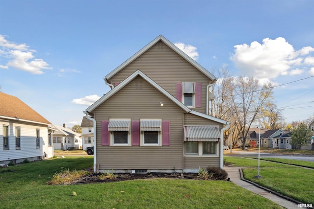 view of side of home with a yard