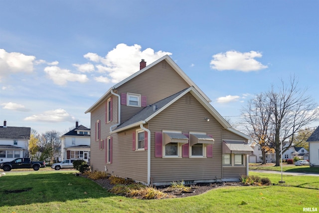 view of home's exterior with a lawn