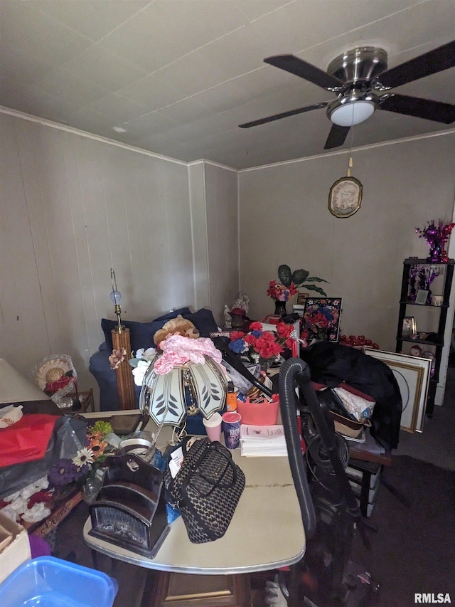 interior space with wooden walls and ceiling fan