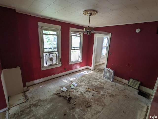 unfurnished dining area featuring ornamental molding and ceiling fan