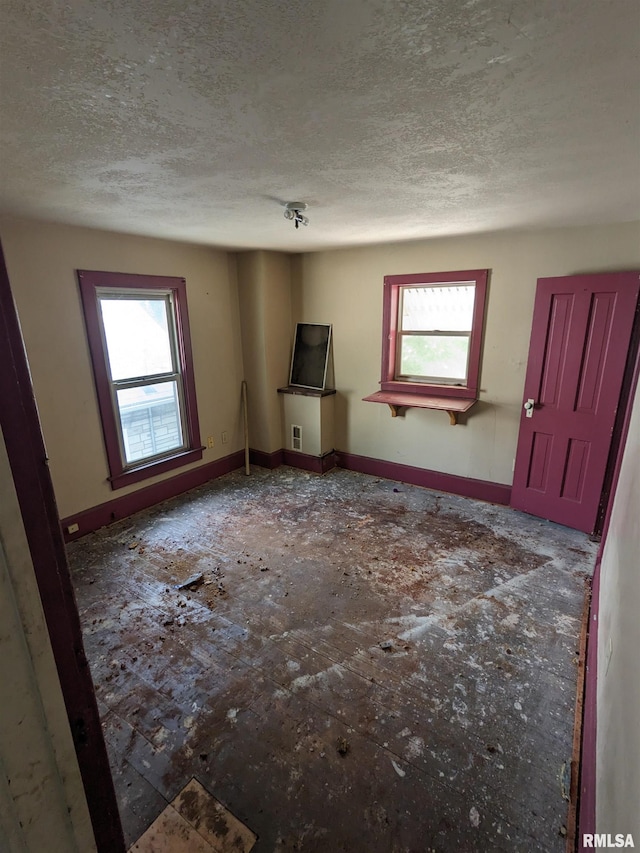 interior space featuring a textured ceiling and a healthy amount of sunlight