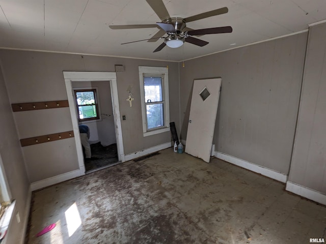 entryway with ceiling fan and crown molding